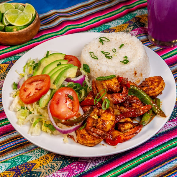 Cafe772 Cantina & Grill's Latin-American shrimp dish with rice, avocado, tomatoes, and salad.